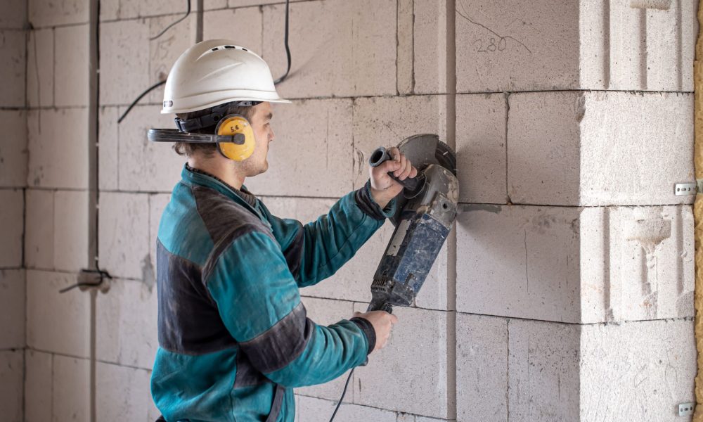 professional-builder-work-clothes-works-with-cutting-tool